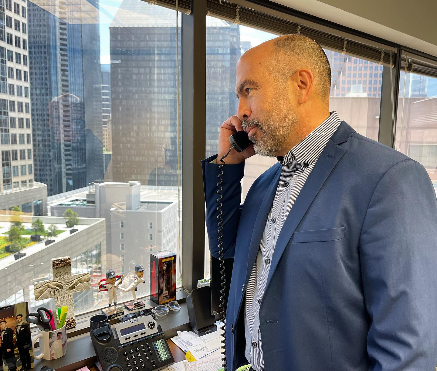 Frank H. Stambaugh taking a client call at his downtown Houston office